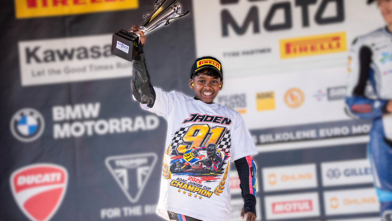 Jaden Immanuel celebrating with a trophy after winning the 2026 ADAC Junior Cup as the first Indian European motorcycle champion.